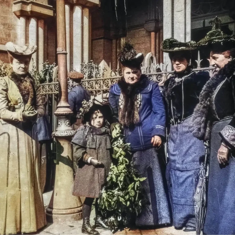4 femmes élégantes avec des chapeaux et un enfant tenant un sapin de Noël au début du XXe Siècle